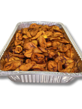 Aluminum tray filled with fried plantains on a white background