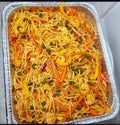 Spaghetti dish with vegetables in a foil tray 