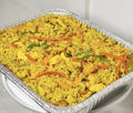 Fried rice with vegetables in a foil container on a white background