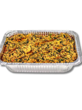 egusi in an aluminum pan on a white background