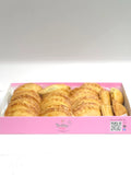Box of meat pies in a pink bok on a white background