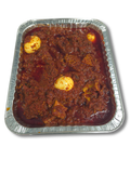 ofada sauce  in a foil pan on a white background
