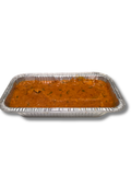 Foil pan with ogbono sauce on a white background